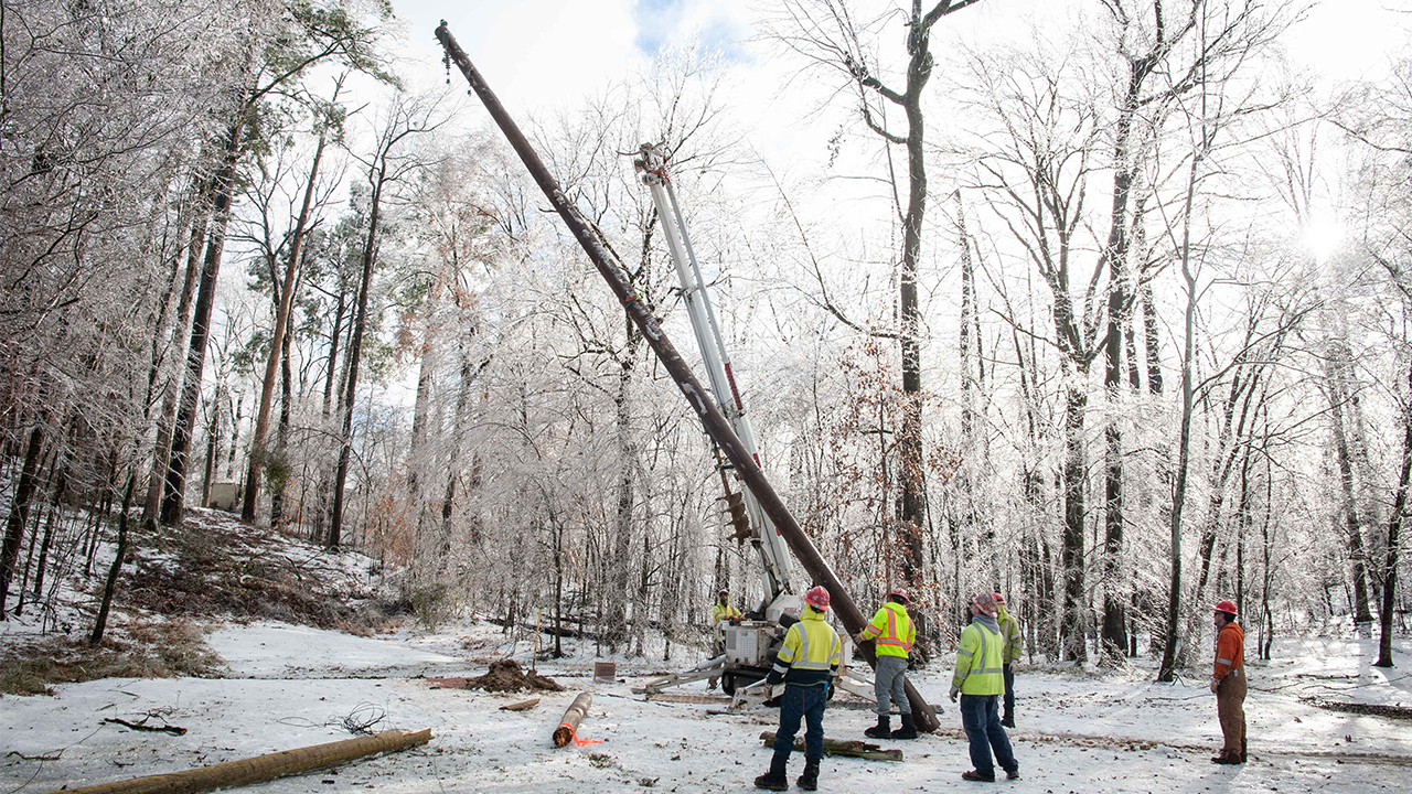 Crews set a power pole in Vicksburg, Mississippi.